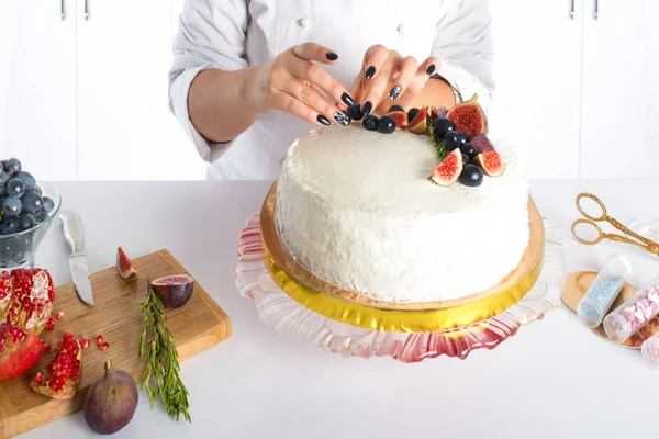 The confectioner decorates cake with fruit Stock Image