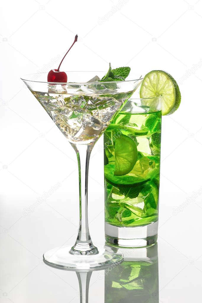two glasses with soft drinks with ice stand on the white reflect