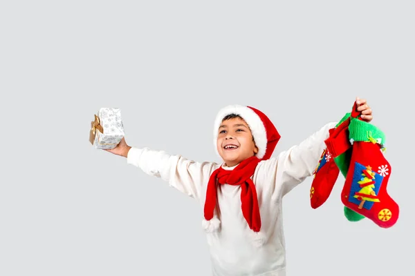 Studio colpo di bambino divertente sorridente in cappello rosso Santa che tiene Chri — Foto Stock