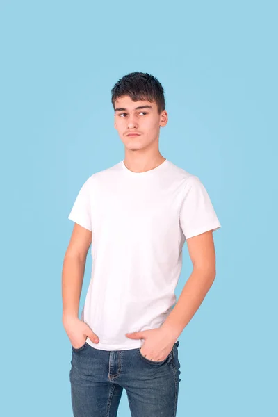 Studio portrait of a serious teenager guy wearing a white shirt — Stok fotoğraf