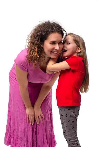 Little daughter whispers  secret to her mother in her ear, and h — 스톡 사진