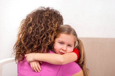 Küçük kız annesine sevgiyle sarılıyor..   