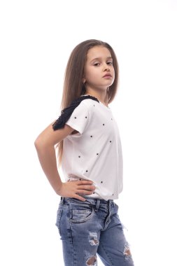 Half length portrair  of a young  girl wearing  jeans and a  whi