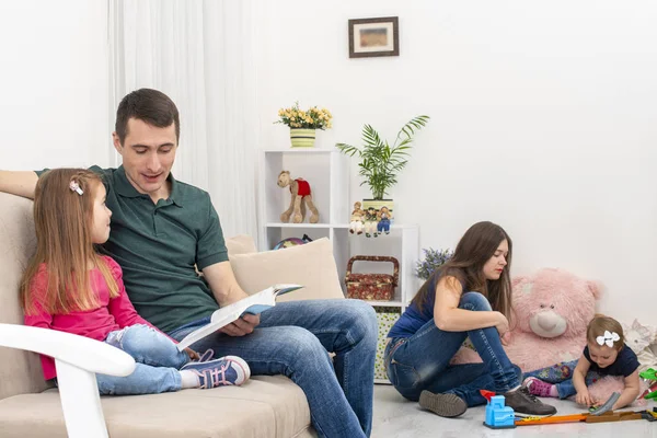 Shot of young family with two young children spending time at home.  The concept of family values.  Life style.