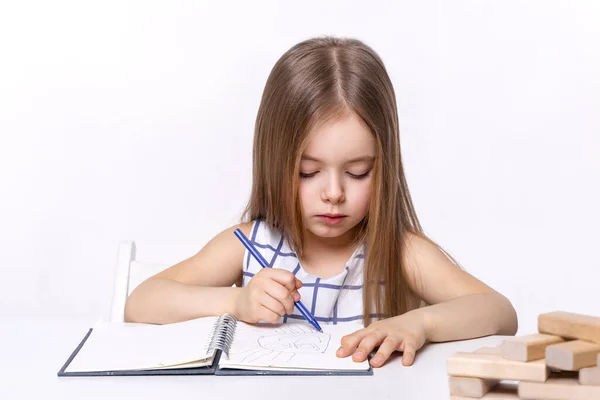 Tiro Menina Sentada Uma Mesa Branca Desenho Caderno Seu Brinquedo — Fotografia de Stock