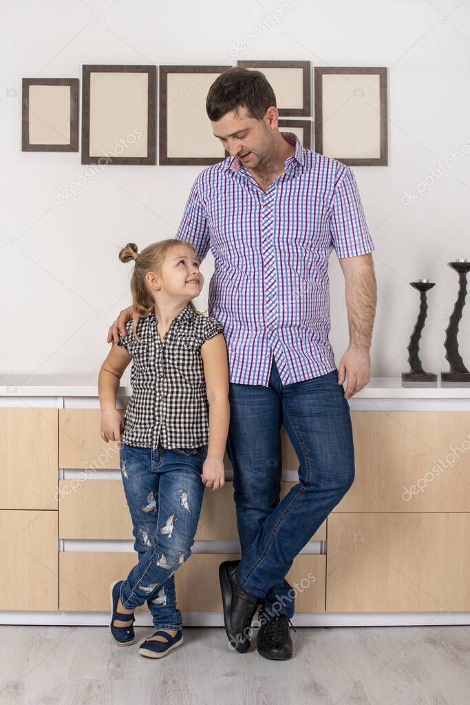Shot of dad and daughter  spending time together at home. Daughter imitates her father.