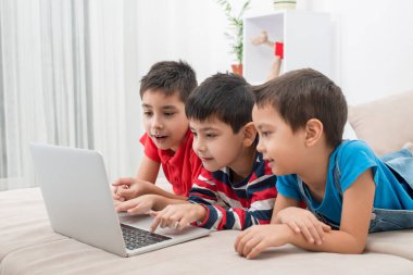 Üç kardeş ya da arkadaş bir dizüstü bilgisayarla stajyeri araştırıyor. Modern yaşam tarzı.  