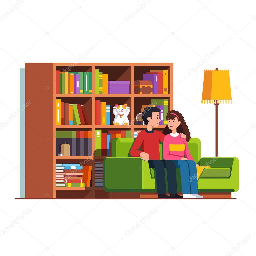 Husband and wife sitting on sofa at living room