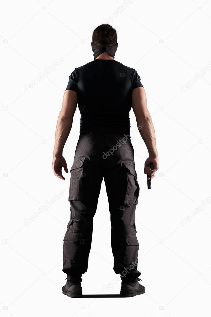 Man in black uniform with gun isolated on white