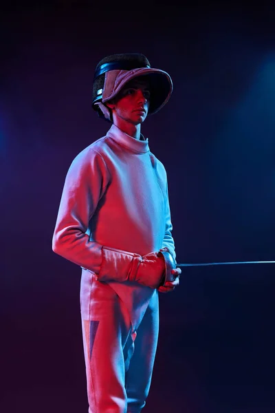 Male fencer standing on black background — Stock Photo, Image