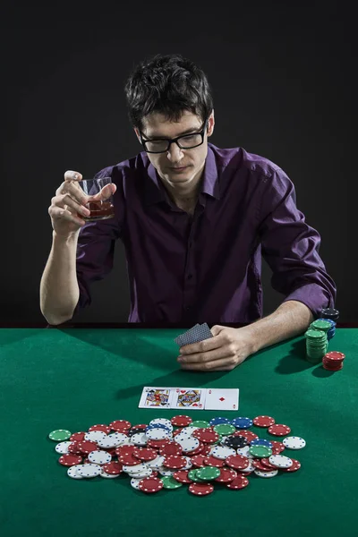 Casino player in glasses playing poker Stock Image