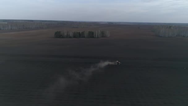 Tractor Plows Huge Field Background Forest Spring Trees Leaves Evening — Stock Video