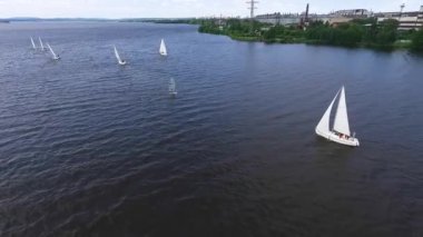 Yarış. Şehir göletindeki sanayi manzaralı yelkenli yatlarının hava manzarası.