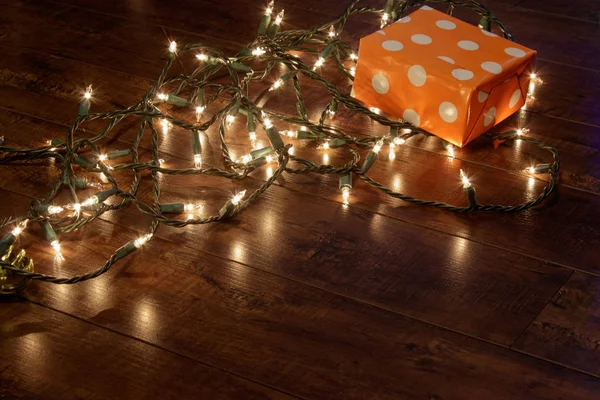 string of white lights laying on floor to decorate for christmas