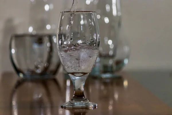 water poured over ice in glass