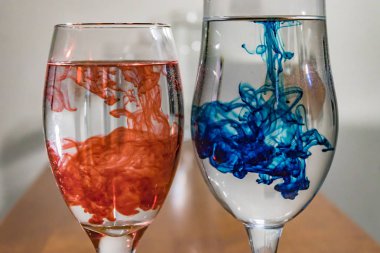 wine glasses with red and blue dye clipart