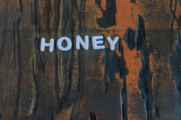 Μέλι γραμμένο με λευκά γράμματα — Φωτογραφία Αρχείου