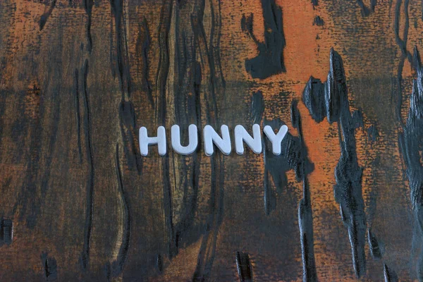 La palabra hunny escrita en letras blancas — Foto de Stock