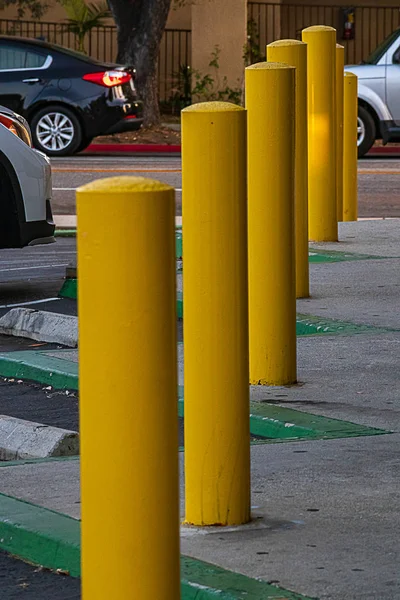 A row of metal poles limiting cars from hitting sidewalk — Stock Photo, Image