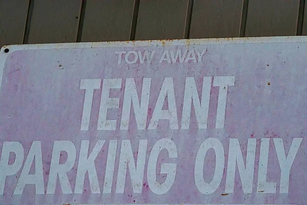 Old faded metal sign rusted with white words tenant parking — Stock Photo, Image