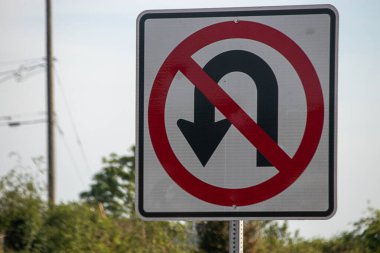 no u-turn sign attached to a metal pole
