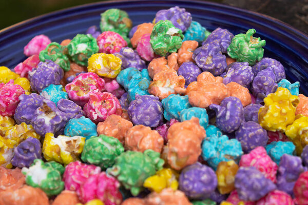 blue plate with bright multi colored popcorn