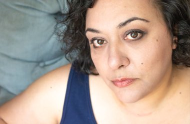 Mavi sandalyedeki güzel melez kadın.