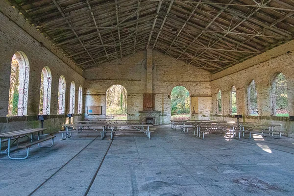 An old brick millitary building in a park used for a picnic area — 스톡 사진