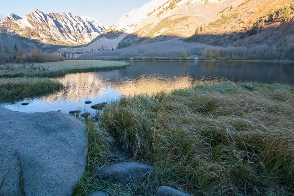 morning glow of light on mountain peaks and lake