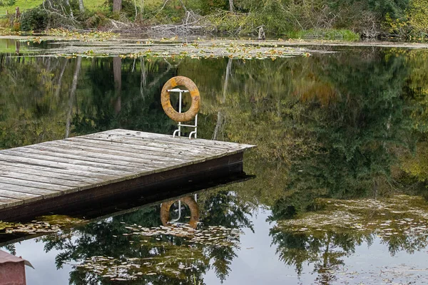 Drijvende ring aan steiger in klein meer — Stockfoto