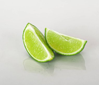 Beyaz bir arkaplanda yansıması olan limon dilimi