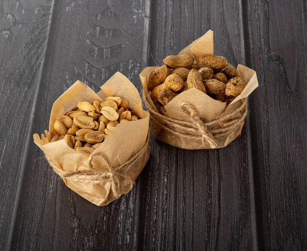 Karanlık bir arka planda el işi kağıdındaki fıstıklar.