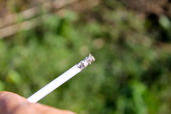 Slim cigarette in hand — Stock Photo, Image