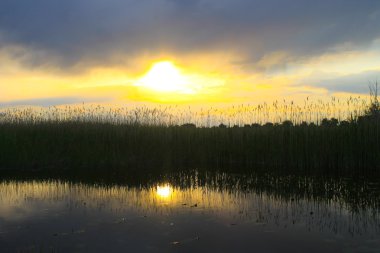 Sakin gölün üzerinde güzel bir gün batımı