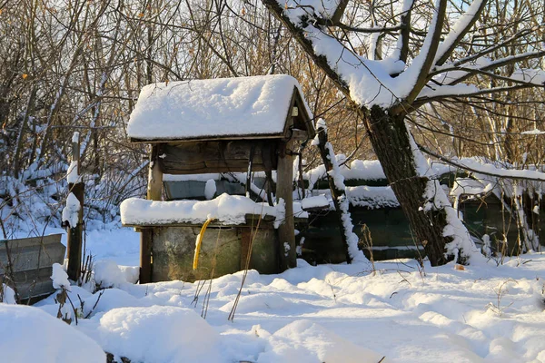 Old draw-well in ukrainian village on winter