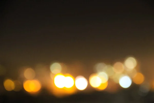 Abstract background of blurred city lights with bokeh effect — Stock Photo, Image