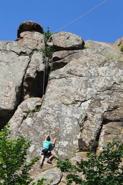 Junge klettert auf einen Felsen — Stockfoto