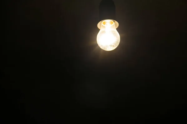 Electric light bulb on dark background — Stock Photo, Image