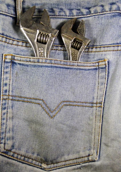 Wrench tools in a blue pocket jeans — Stock Photo, Image
