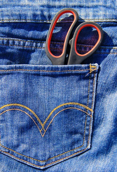 Pair of scissors in pocket of blue jeans — Stock Photo, Image