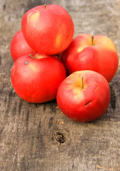 Red apples on wooden background — Stock Photo, Image