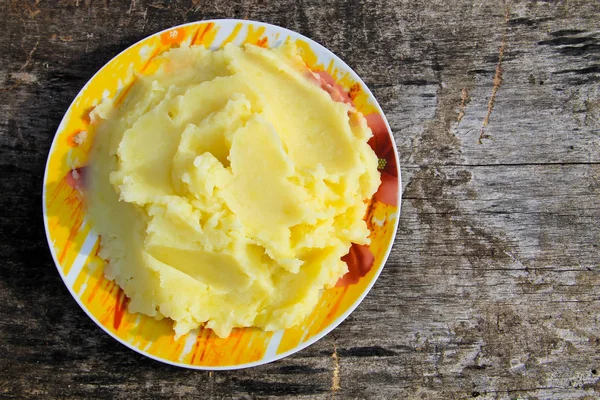 Puré de papas en un plato sobre una mesa de madera rústica —  Fotos de Stock