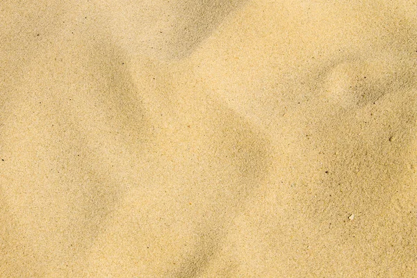 Písčitá textura. Písečná pláž pro pozadí — Stock fotografie