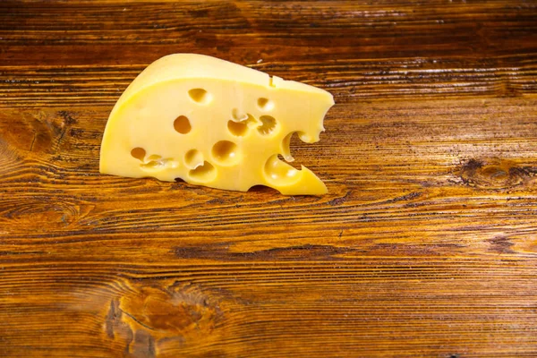 Stuk kaas op houten achtergrond — Stockfoto