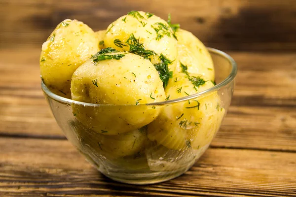 Tereyağı ve ahşap masa üzerine dereotu ile yeni haşlanmış patates