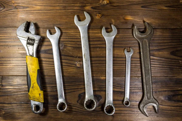 Old wrench tools on wooden background — Stock Photo, Image