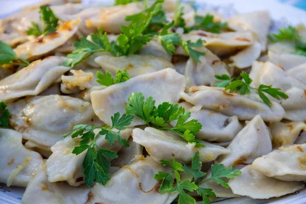 Tasty dumplings or vareniki with fried onion and parsley — Stock Photo, Image