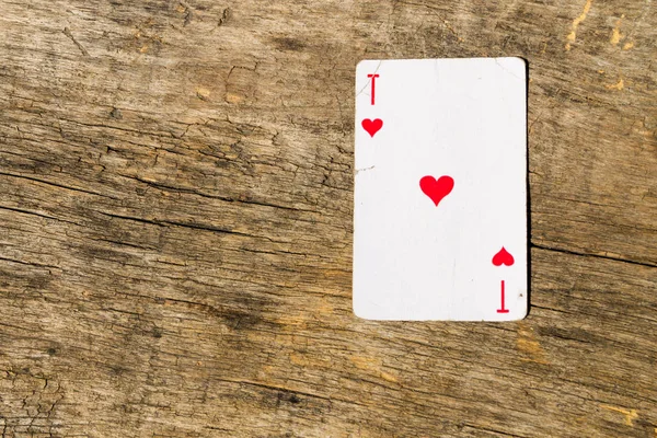 Ace of hearts on old wooden background — Stock Photo, Image