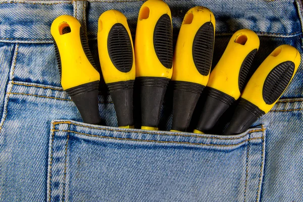 Screwdrivers in pocket of blue jeans — Stock Photo, Image