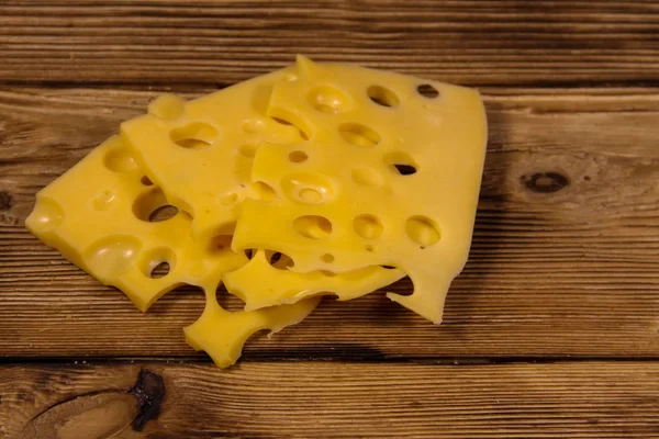 Sliced swiss cheese on wooden table — Stock Photo, Image